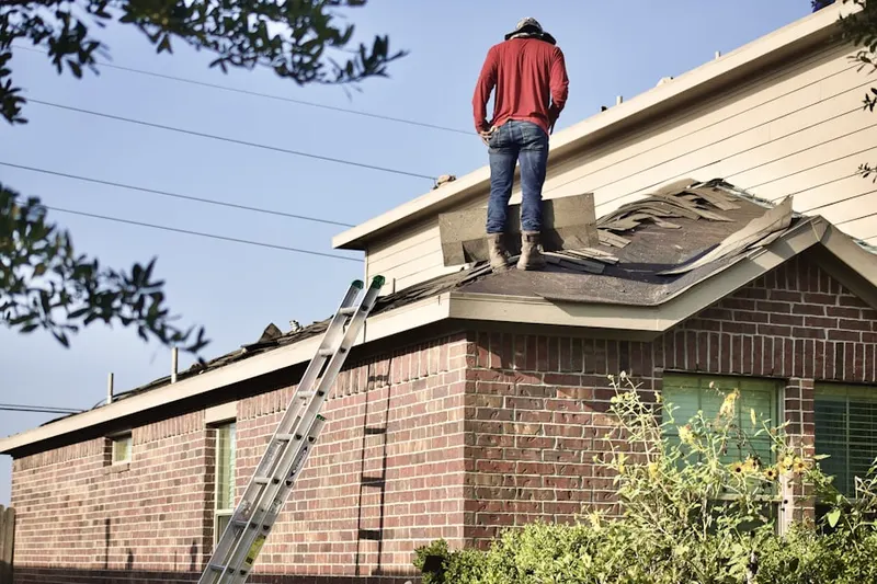 Professional roofer working on a residential roof in Apalache
